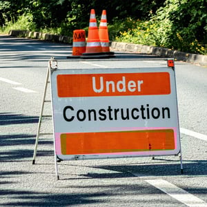 under construction sign in front of street