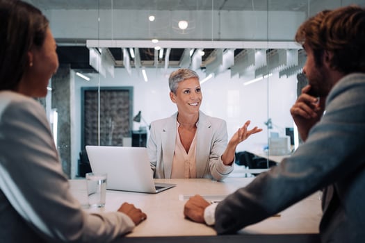 Association manager interviewing at an office desk