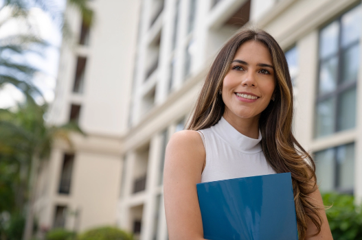 Manager standing outside of a high-rise condo community